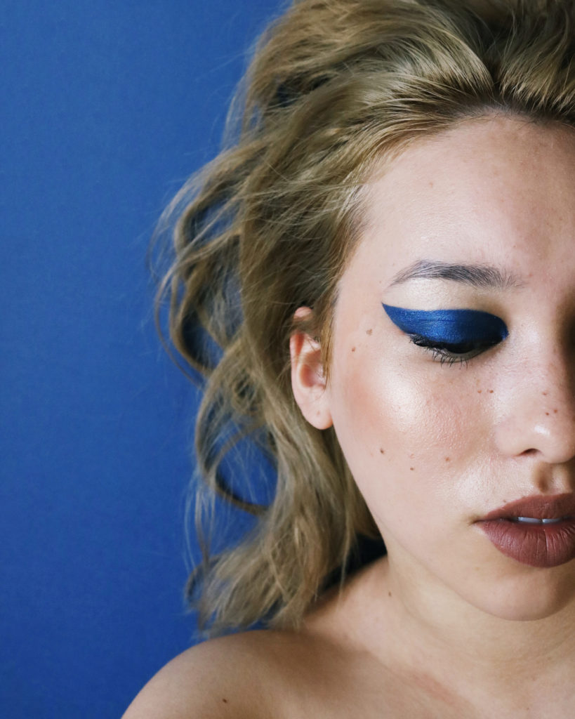 model with chunky blue eyeliner