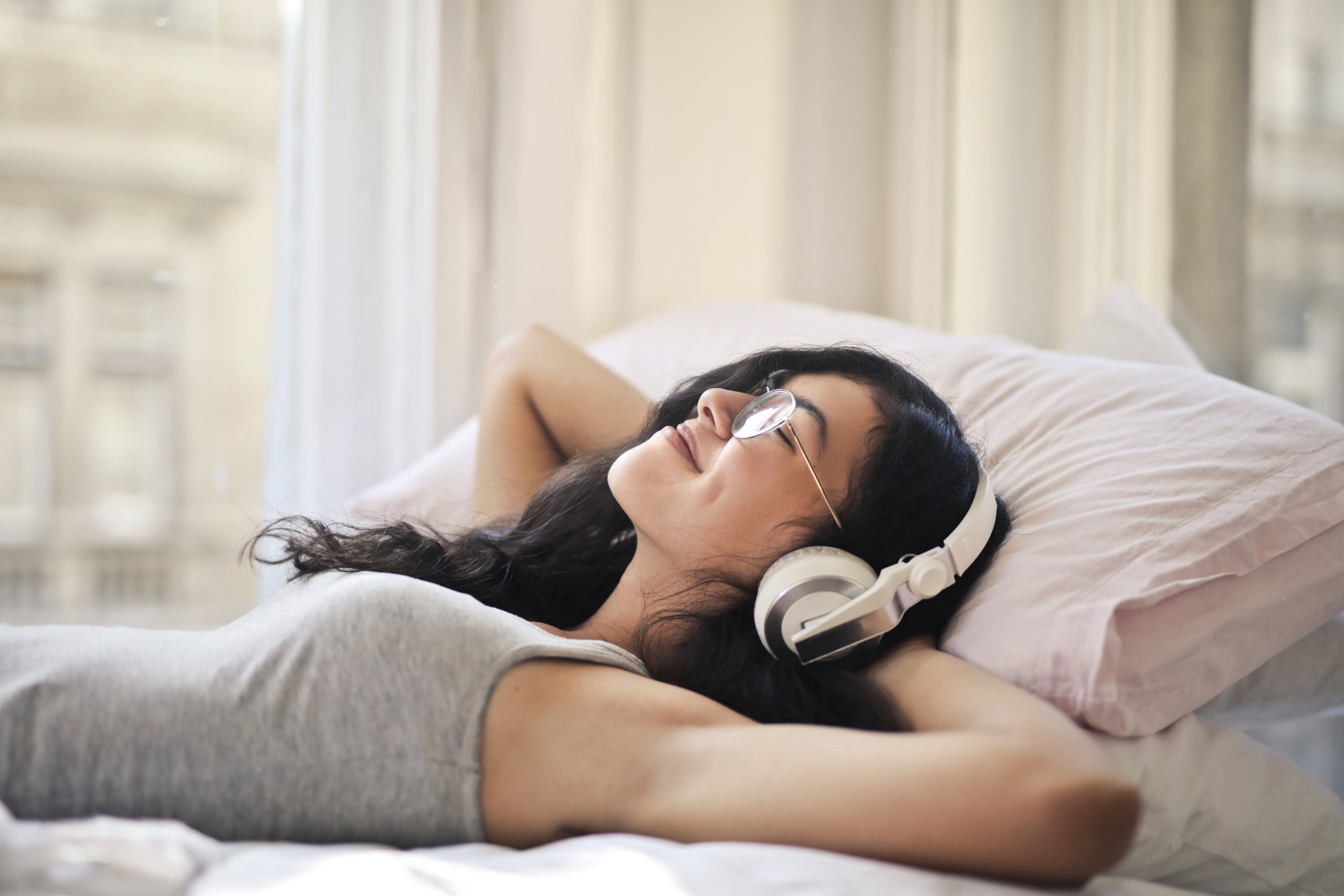 a woman listening to music through earphones